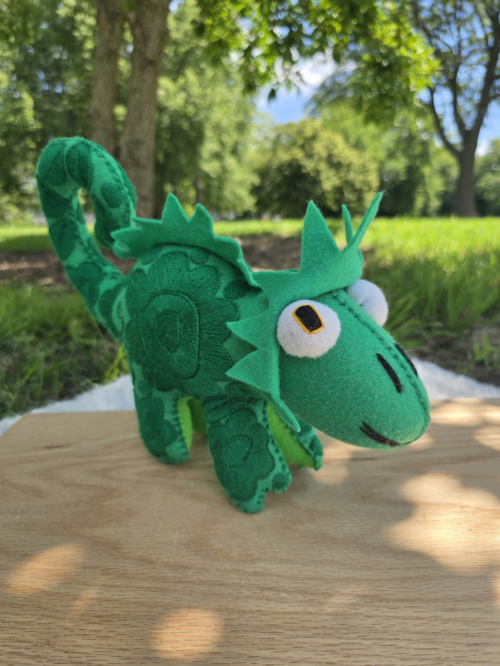 handmade green felt iguana features intricate embroidered floral patterns